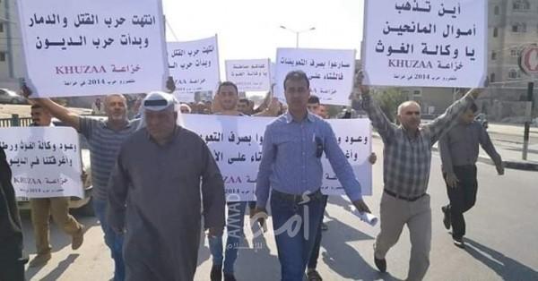 خلال وقفة: متضررو عدوان 2014 يطالبون "أونروا" بصرف تعويضاتهم
